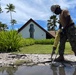 U.S. Navy Seabees with NMCB-5's Detail Marshall Islands place concrete for a church sidewalk