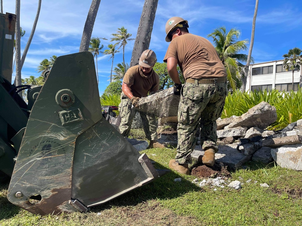 U.S. Navy Seabees with NMCB-5's Detail Marshall Islands place concrete for a church sidewalk