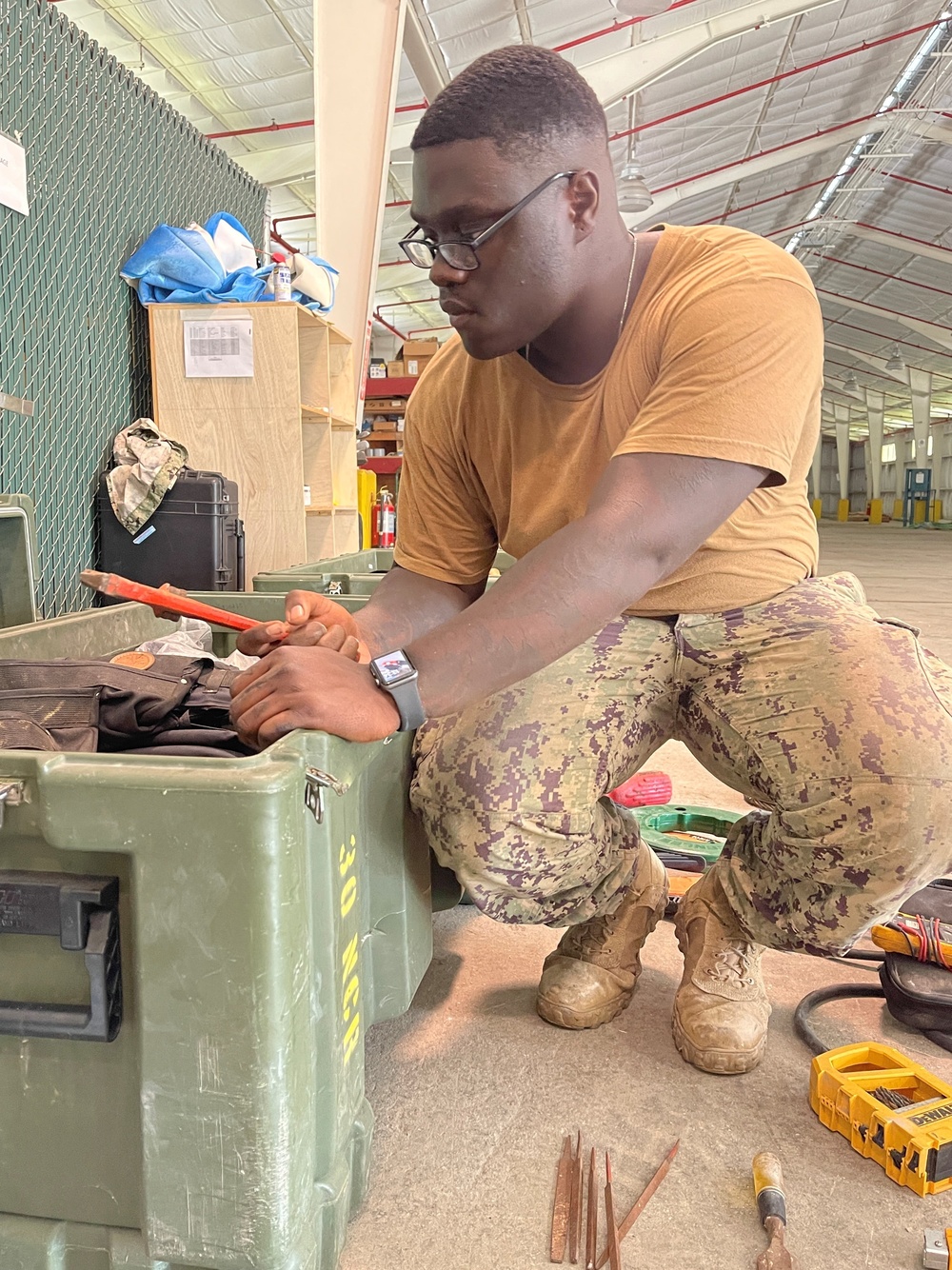 U.S. Navy Seabees assigned to NMCB-5's Detail Diego Garcia inventory tools