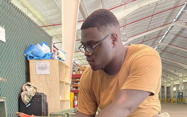 U.S. Navy Seabees assigned to NMCB-5's Detail Diego Garcia inventory tools