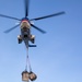 BM2 Jonathan Kosfeld directs a 330J Puma Helicopter assigned to the USNS Alan Shepard