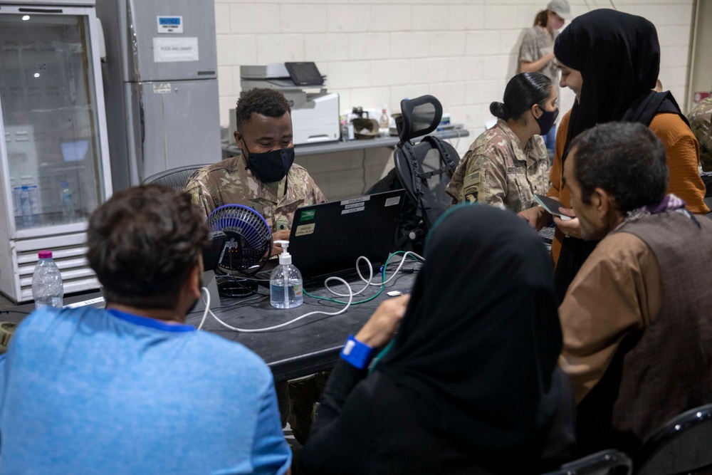 Soldiers Process Afghan Evacuees in Qatar