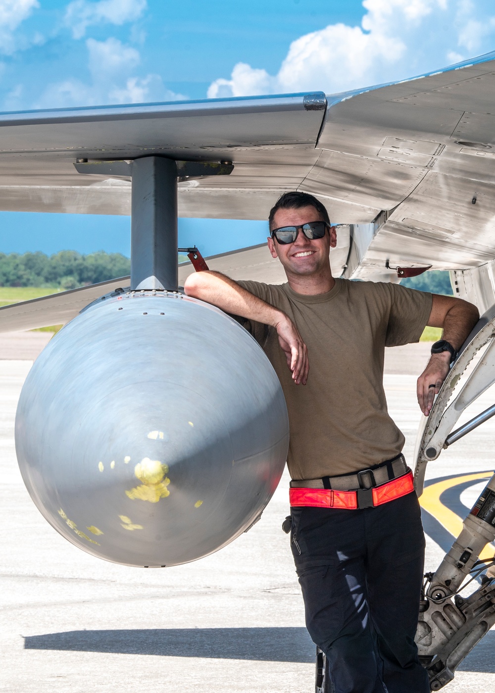 Crew chief poses with a F-16 Fighting Falcon