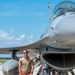 Crew chief poses with a F-16 Fighting Falcon