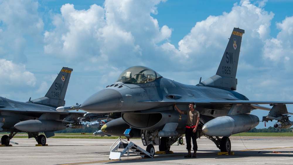 Crew chief checks over a F-16 Fighting Falcon