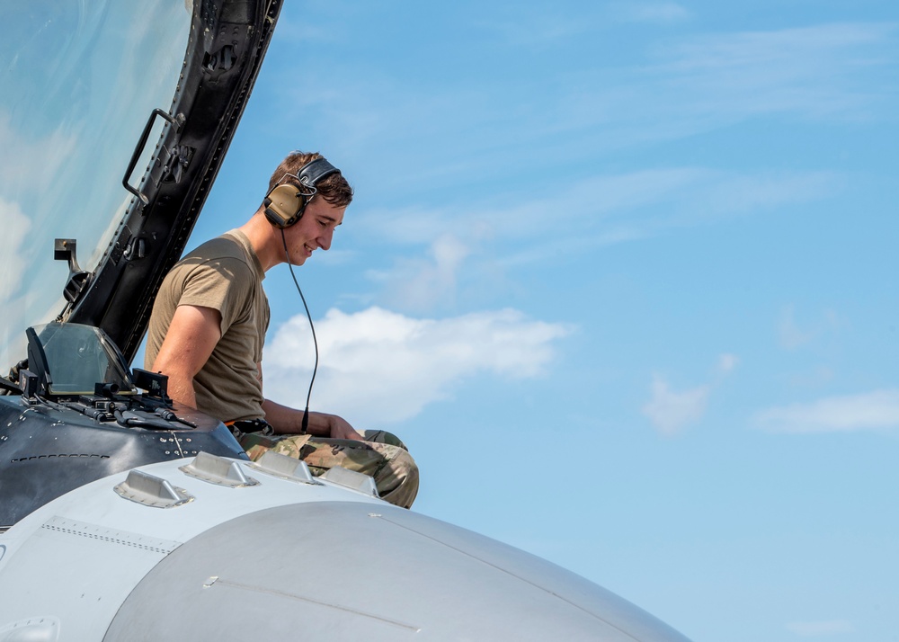 Avionics technician preforms a preflight check on a F-16 Fighting Falcon