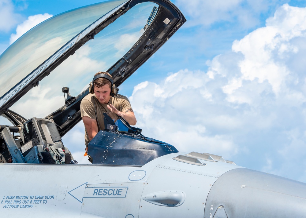 Avionics technician preforms a preflight check on a F-16 Fighting Falcon