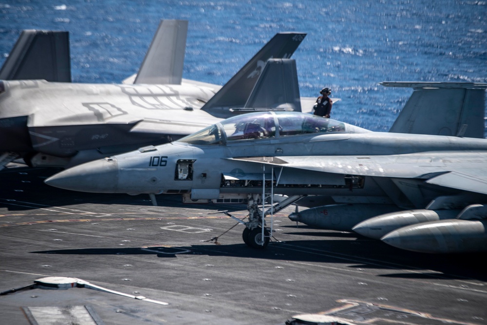 USS Carl Vinson (CVN 70) Sailor cleans aircraft