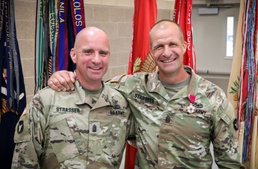A ‘family business’: top enlisted leader of Iowa brigade passes unit colors to brother