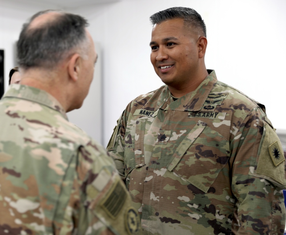 Lt. Gen. Paul Calvert coins Soldiers of Task Force Phoenix at Camp Buehring