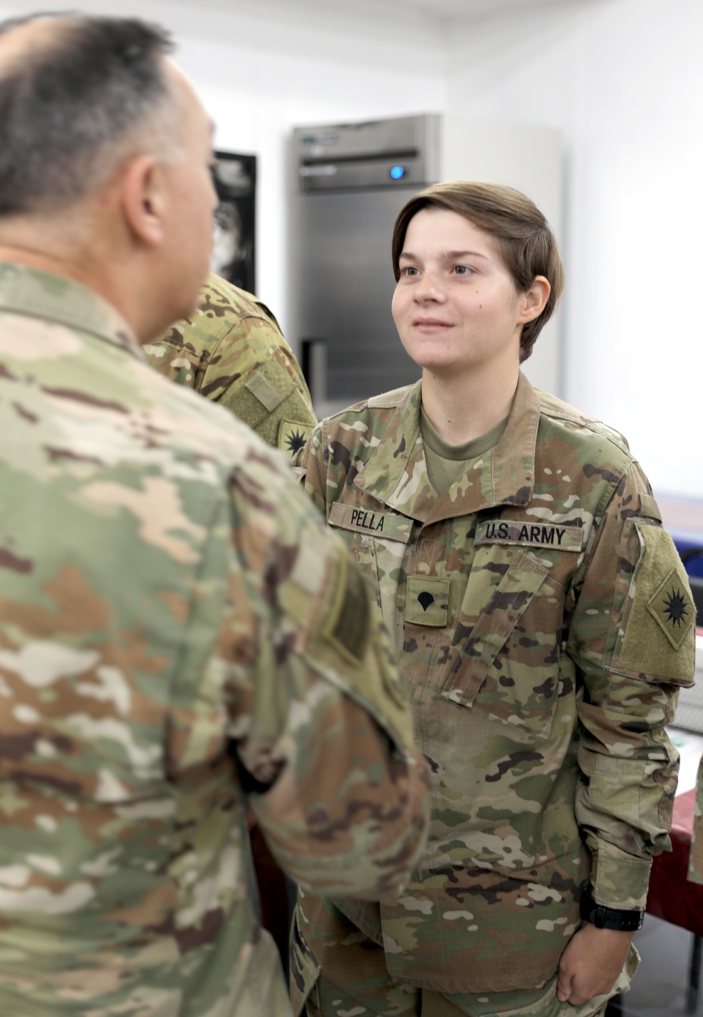 Lt. Gen. Paul Calvert coins Soldiers of Task Force Phoenix at Camp Buehring