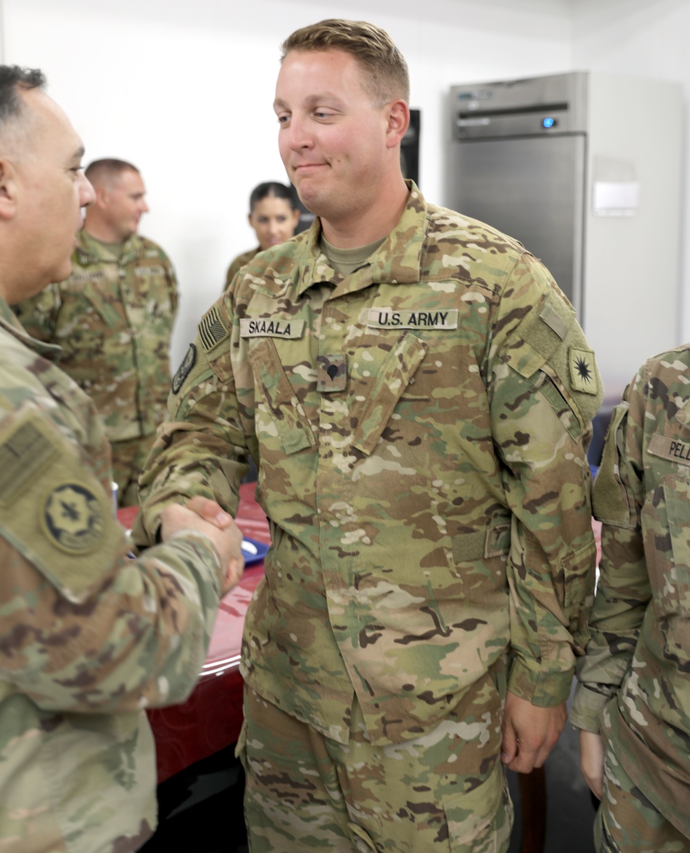 Lt. Gen. Paul Calvert coins Soldiers of Task Force Phoenix at Camp Buehring