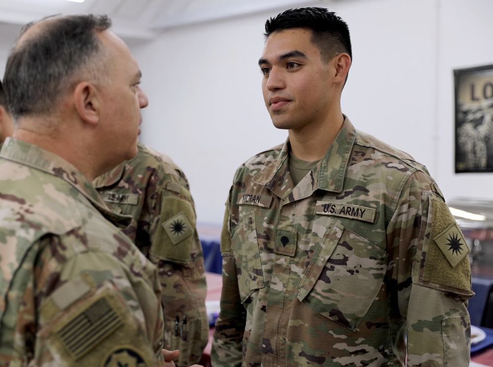 Lt. Gen. Paul Calvert coins Soldiers of Task Force Phoenix at Camp Buehring