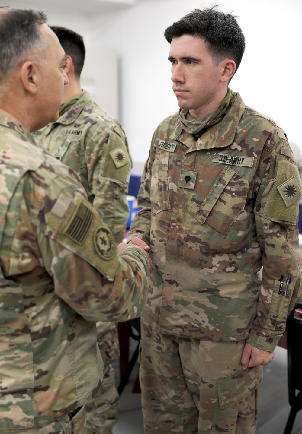 Lt. Gen. Paul Calvert coins Soldiers of Task Force Phoenix at Camp Buehring
