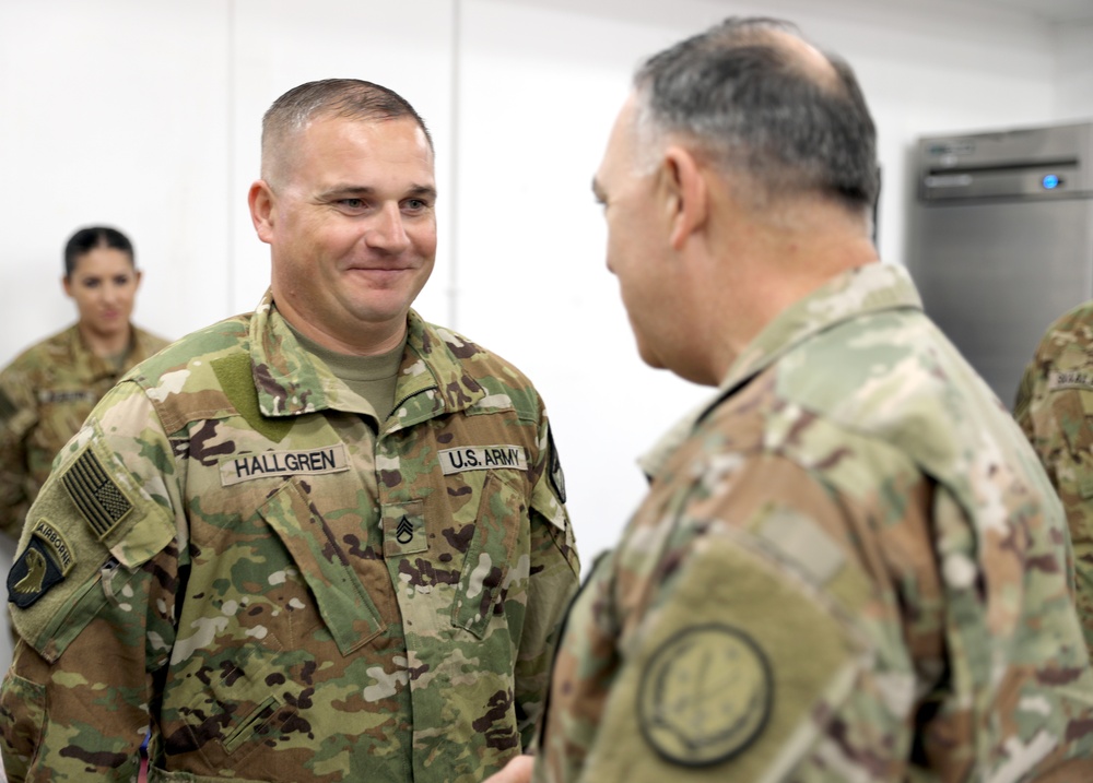 Lt. Gen. Paul Calvert coins Soldiers of Task Force Phoenix at Camp Buehring
