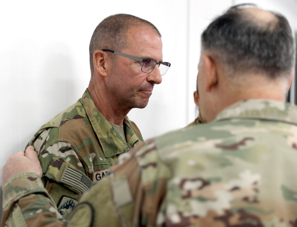 Lt. Gen. Paul Calvert coins Soldiers of Task Force Phoenix at Camp Buehring