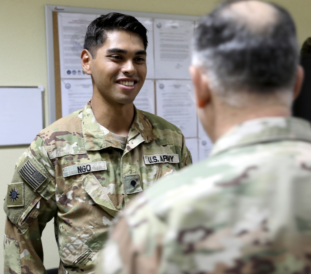 Lt. Gen. Paul Calvert coins Soldiers of Task Force Raptor at Camp Buehring
