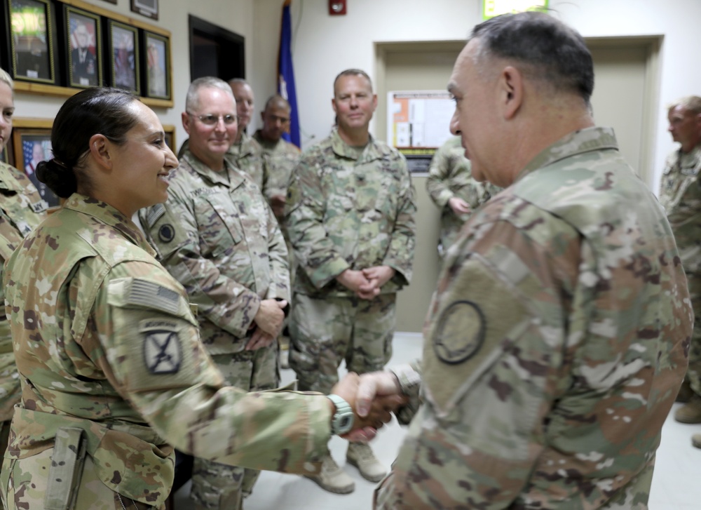 Lt. Gen. Paul Calvert coins Soldiers of Task Force Raptor at Camp Buehring