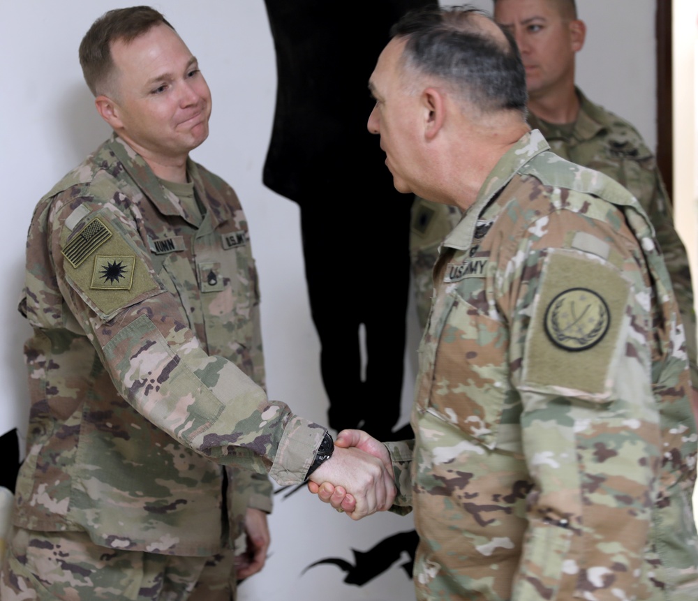 Lt. Gen. Paul Calvert coins Soldiers of Task Force Phoenix, 40th Combat Aviation Brigade at Camp Buehring