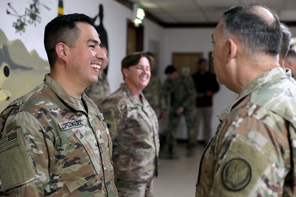 Lt. Gen. Paul Calvert coins Soldiers of Task Force Phoenix, 40th Combat Aviation Brigade at Camp Buehring