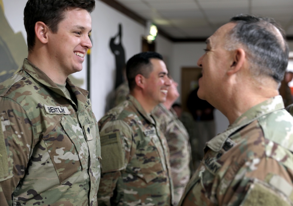 Lt. Gen. Paul Calvert coins Soldiers of Task Force Phoenix, 40th Combat Aviation Brigade at Camp Buehring