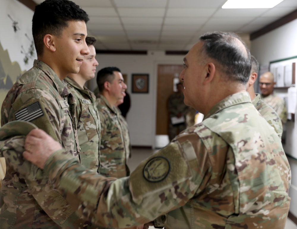 Lt. Gen. Paul Calvert coins Soldiers of Task Force Phoenix, 40th Combat Aviation Brigade at Camp Buehring