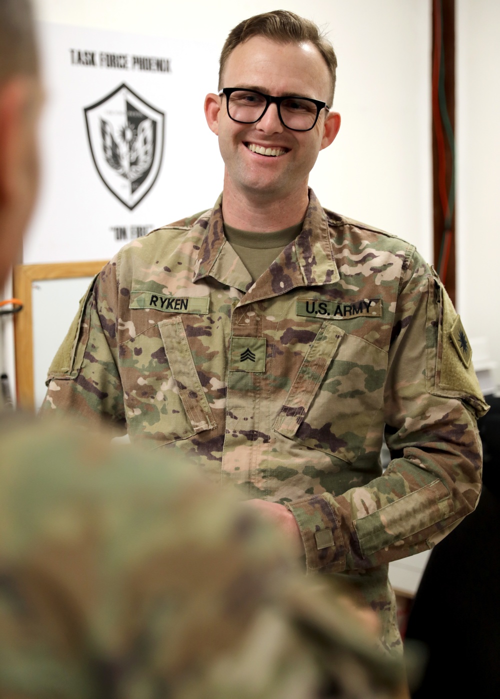 Lt. Gen. Paul Calvert coins Soldiers of Task Force Phoenix, 40th Combat Aviation Brigade at Camp Buehring