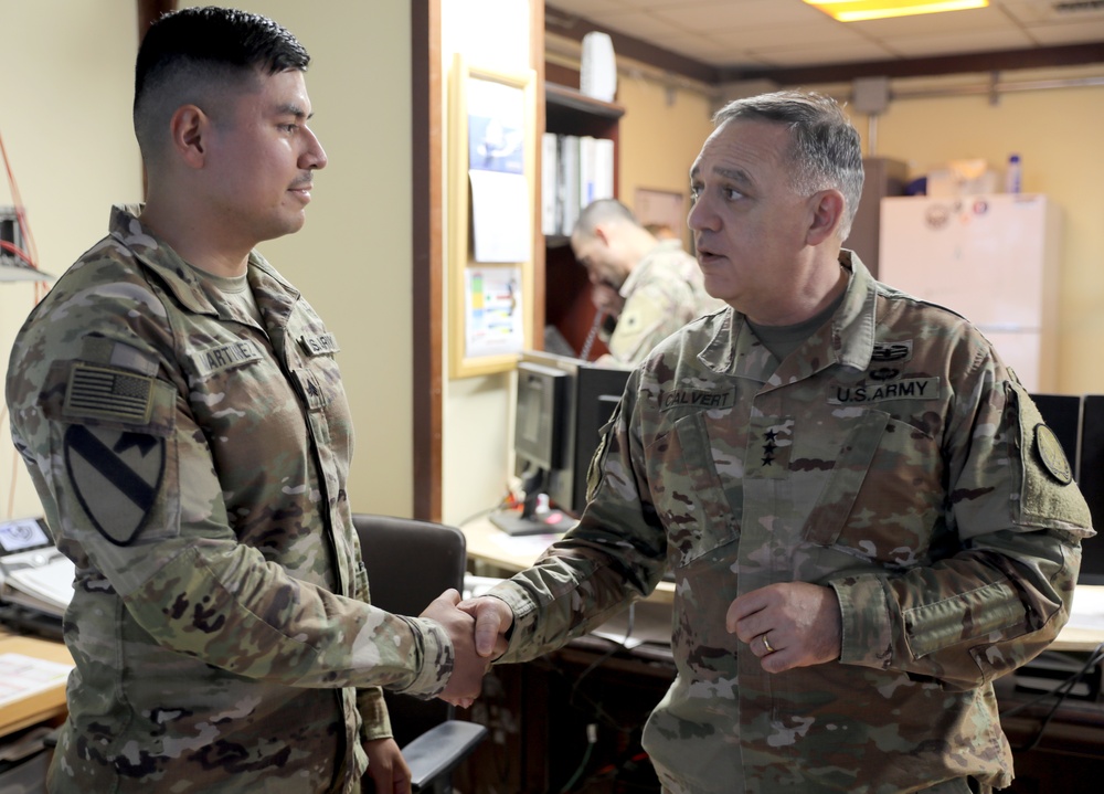 Lt. Gen. Paul Calvert coins Soldiers of Task Force Phoenix, 40th Combat Aviation Brigade at Camp Buehring