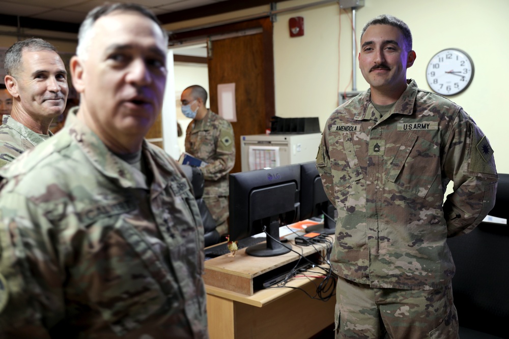 Lt. Gen. Paul Calvert coins Soldiers of Task Force Phoenix, 40th Combat Aviation Brigade at Camp Buehring