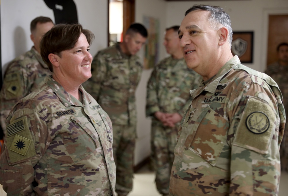 Lt. Gen. Paul Calvert coins Soldiers of Task Force Phoenix, 40th Combat Aviation Brigade at Camp Buehring