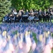 Spectators watch a 9/11 ceremony before a sea of flags