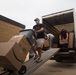 Volunteers unload donations at the National Guard armory