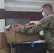 Volunteers unload donations at the National Guard armory