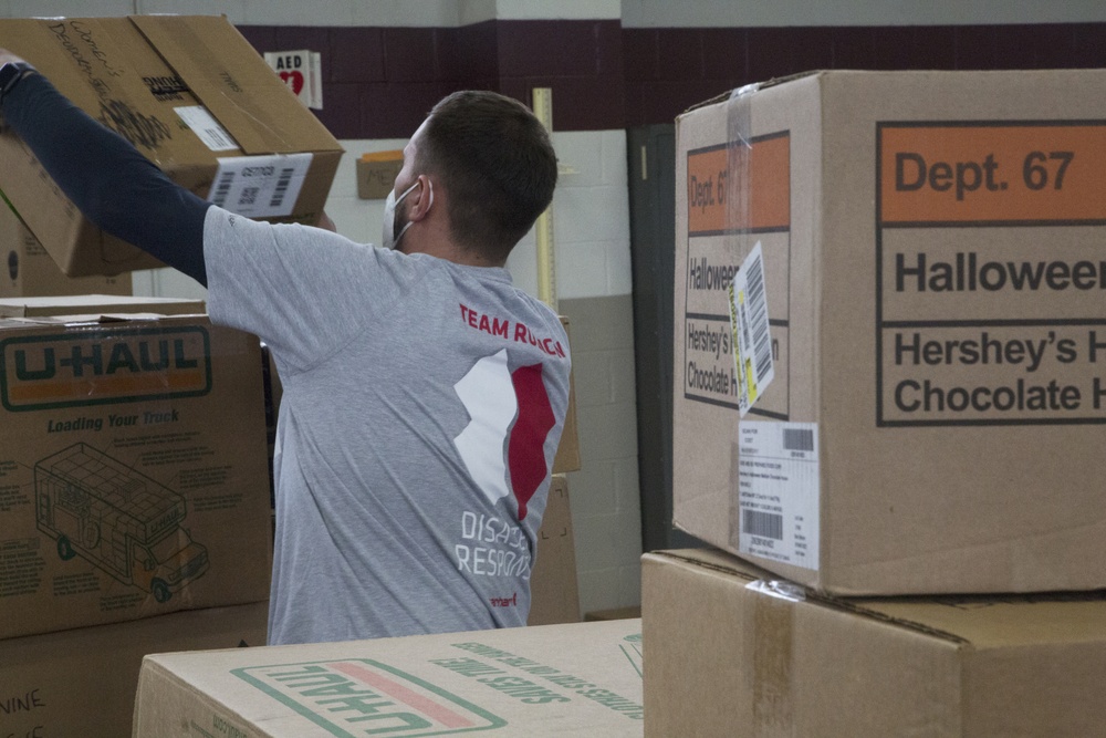 Volunteers unload donations at the National Guard armory