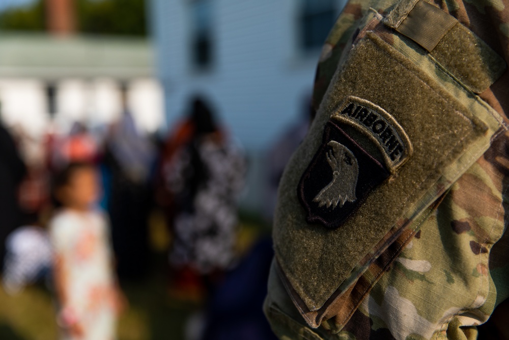 U.S. Army Soldier Guides Afghan Personnel as they Recieve Donations During Operation Allies Welcome at Fort Pickett, Virginia.