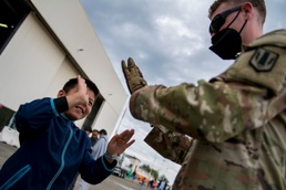 Soldiers put down their Arms to raise others up