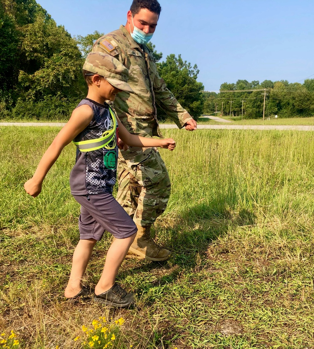 Soldier teaches child to march