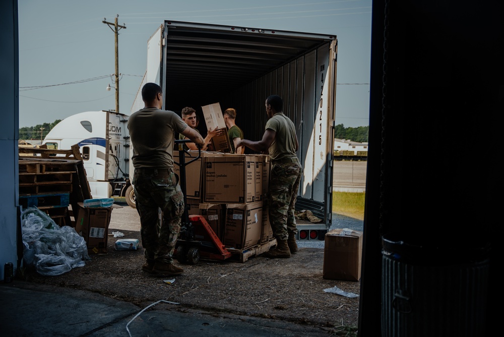 U.S. Marines and Army Soldiers help unload donated supplies in support of Operation Allies Welcome