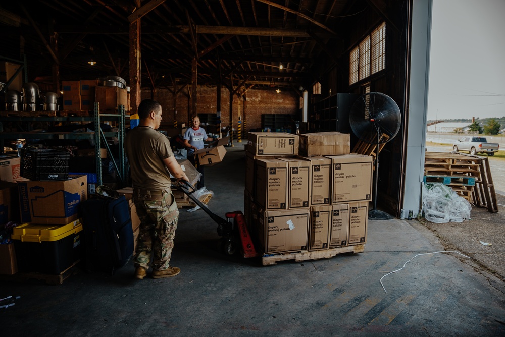 U.S. Marines and Army Soldiers help unload donated supplies in support of Operation Allies Welcome