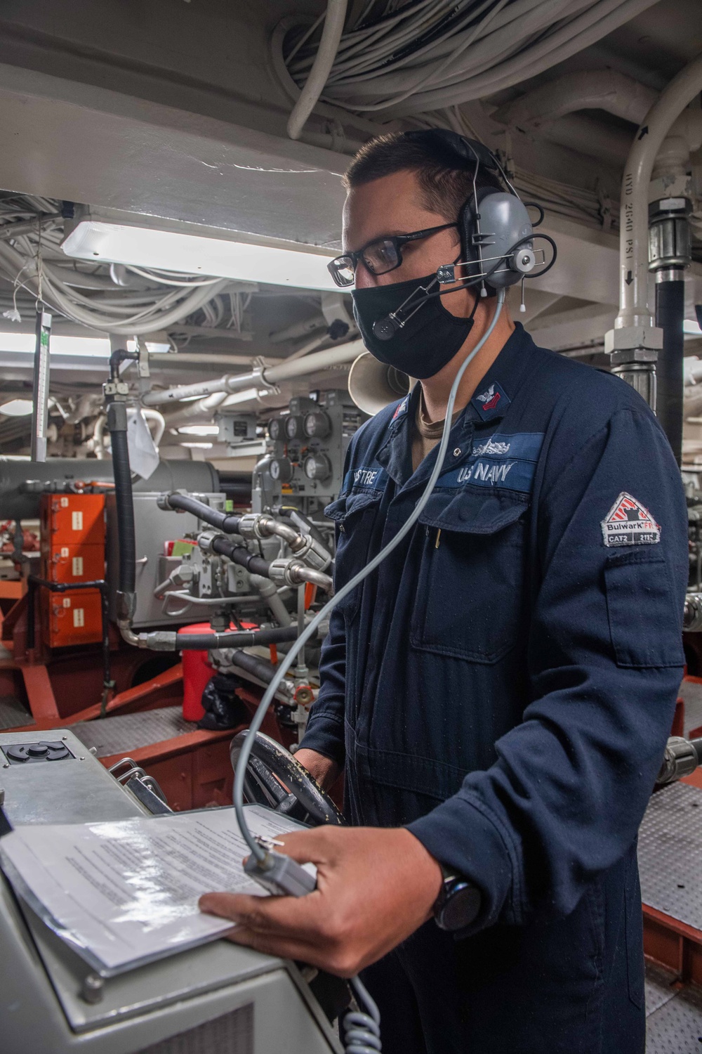 USS Mustin Sailor Pilots the Ship From Aft Steering