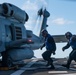 USS Mustin Sailors Approach MH-60R Seahawk helicopter To Remove Chocks and Chains