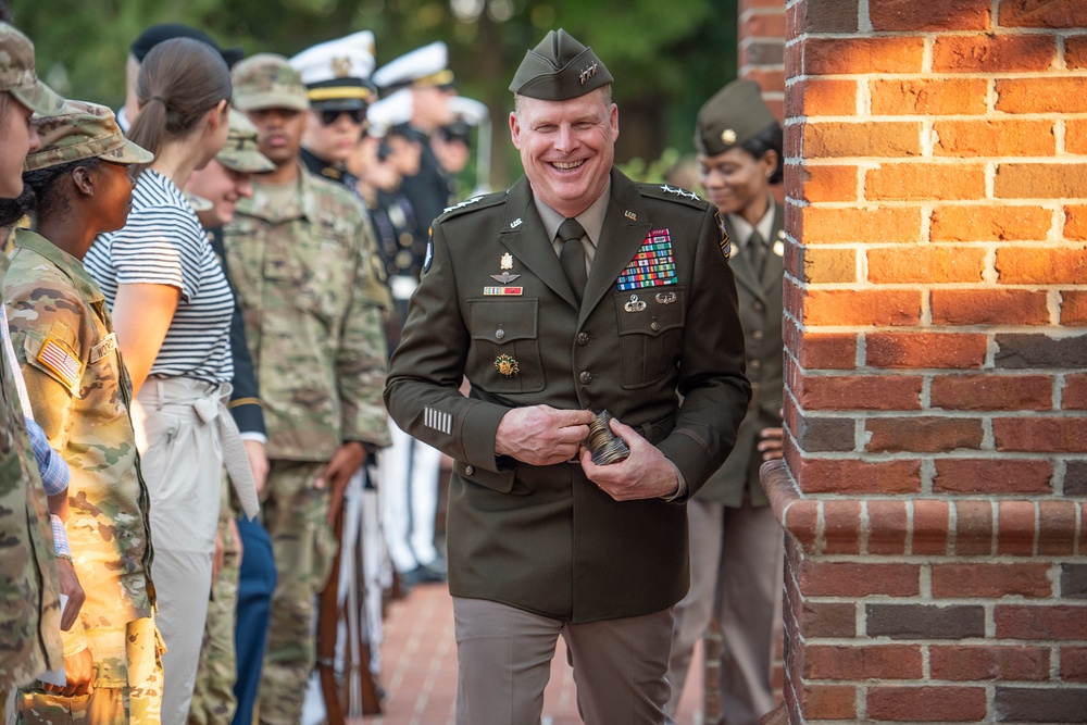 General Duane Gamble hands out coins