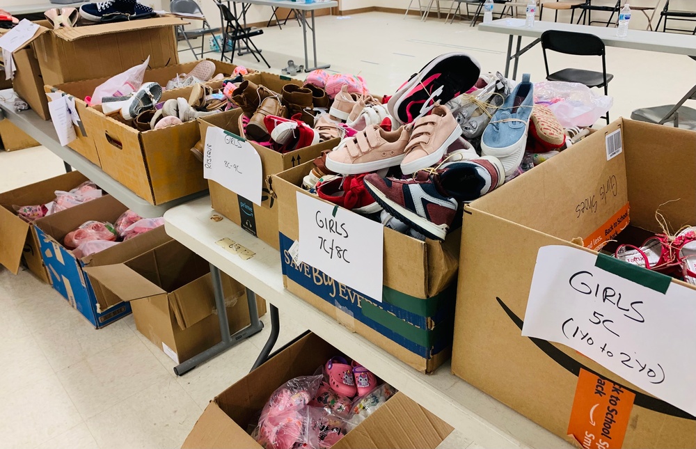 Donated shoes paired up and separated by size are ready to be given out to Families on Doña Ana Village, Sept. 13.