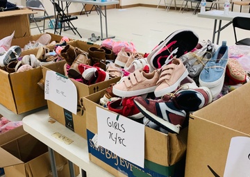 Donated shoes paired up and separated by size are ready to be given out to Families on Doña Ana Village, Sept. 13.