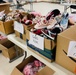 Donated shoes paired up and separated by size are ready to be given out to Families on Doña Ana Village, Sept. 13.