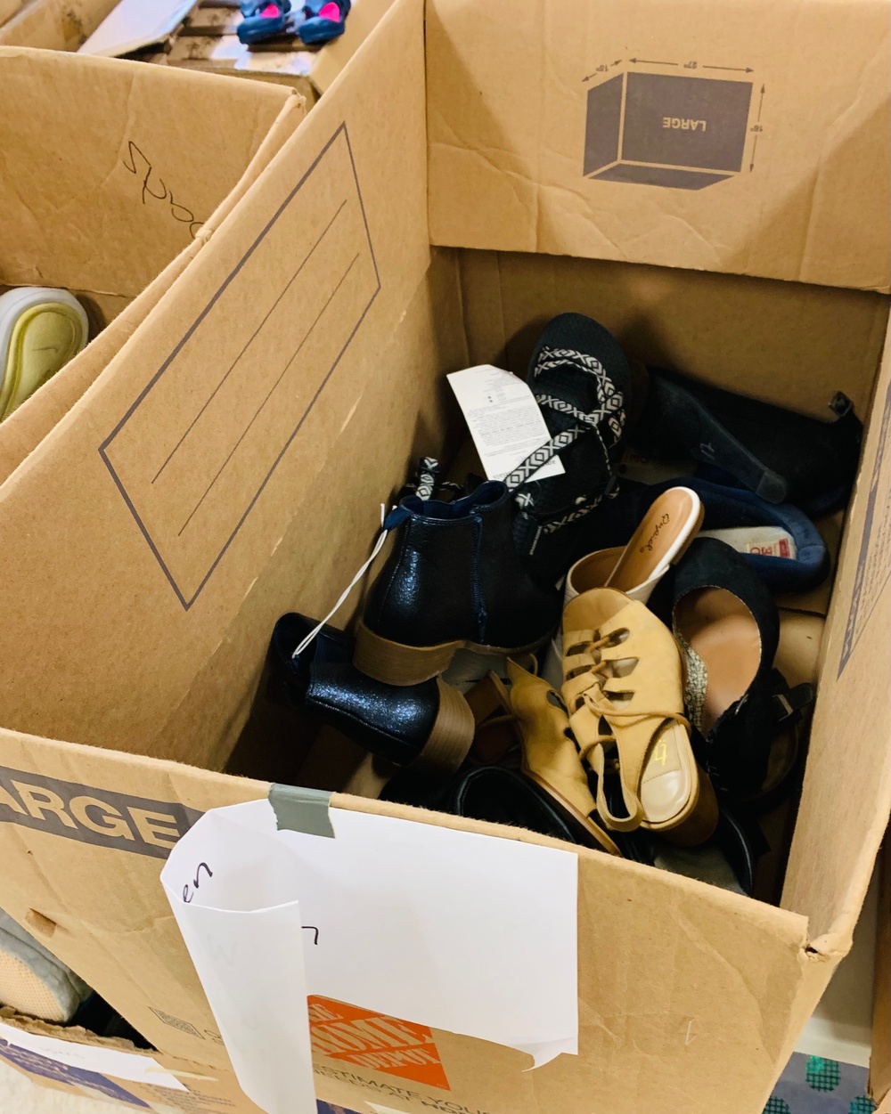 Donated shoes paired up and separated by size are ready to be given out to Families on Doña Ana Village, Sept. 13.