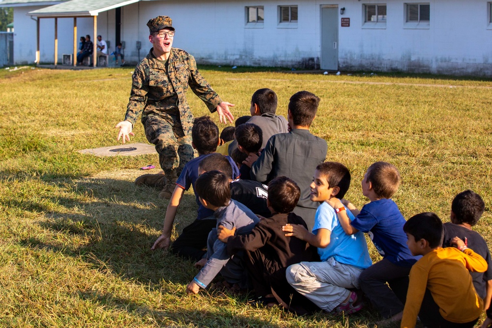 U.S. service members play with Afghan children during Operation Allies Welcome