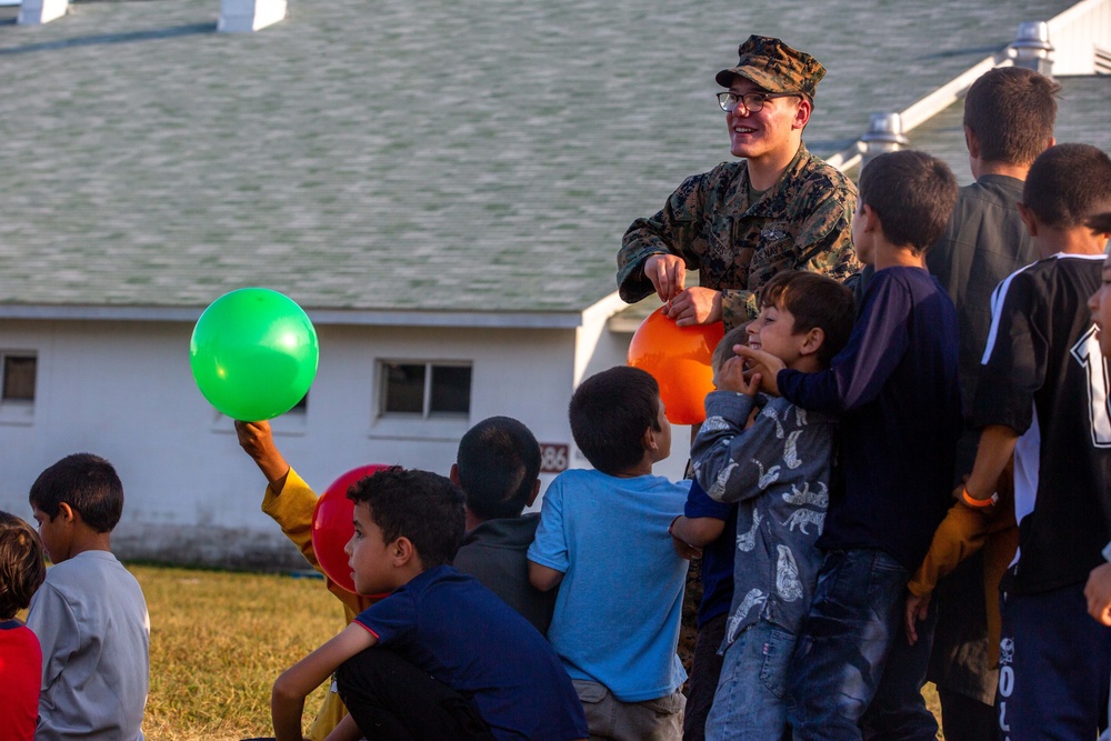 U.S. service members play with Afghan children during Operation Allies Welcome