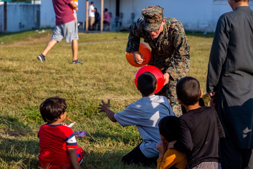 U.S. service members play with Afghan children during Operation Allies Welcome