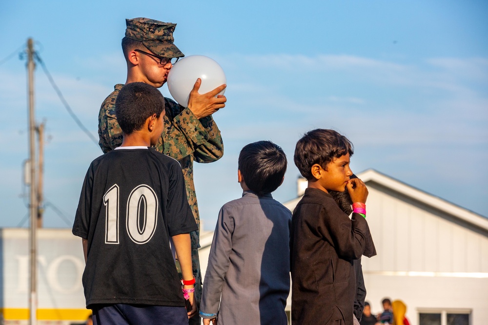 U.S. service members play with Afghan children during Operation Allies Welcome